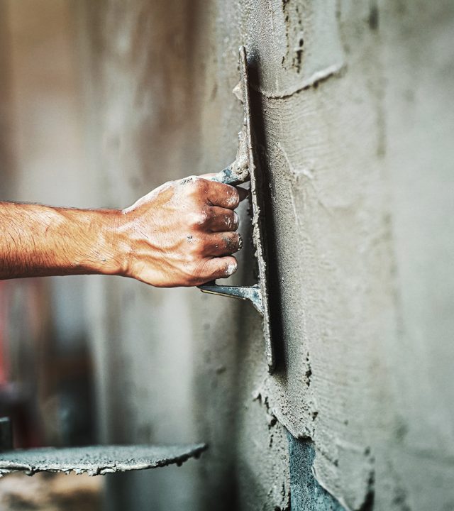 closeup-hand-worker-plastering-cement-wall-building-house closeup-hand-worker-plastering-cement-wall-building-house